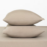 Fitted Sheet with Pillowcases in Almond. Showing 2 pillows stacked on a sheet