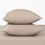 Fitted Sheet with Pillowcases in Almond. Showing 2 pillows stacked on a sheet