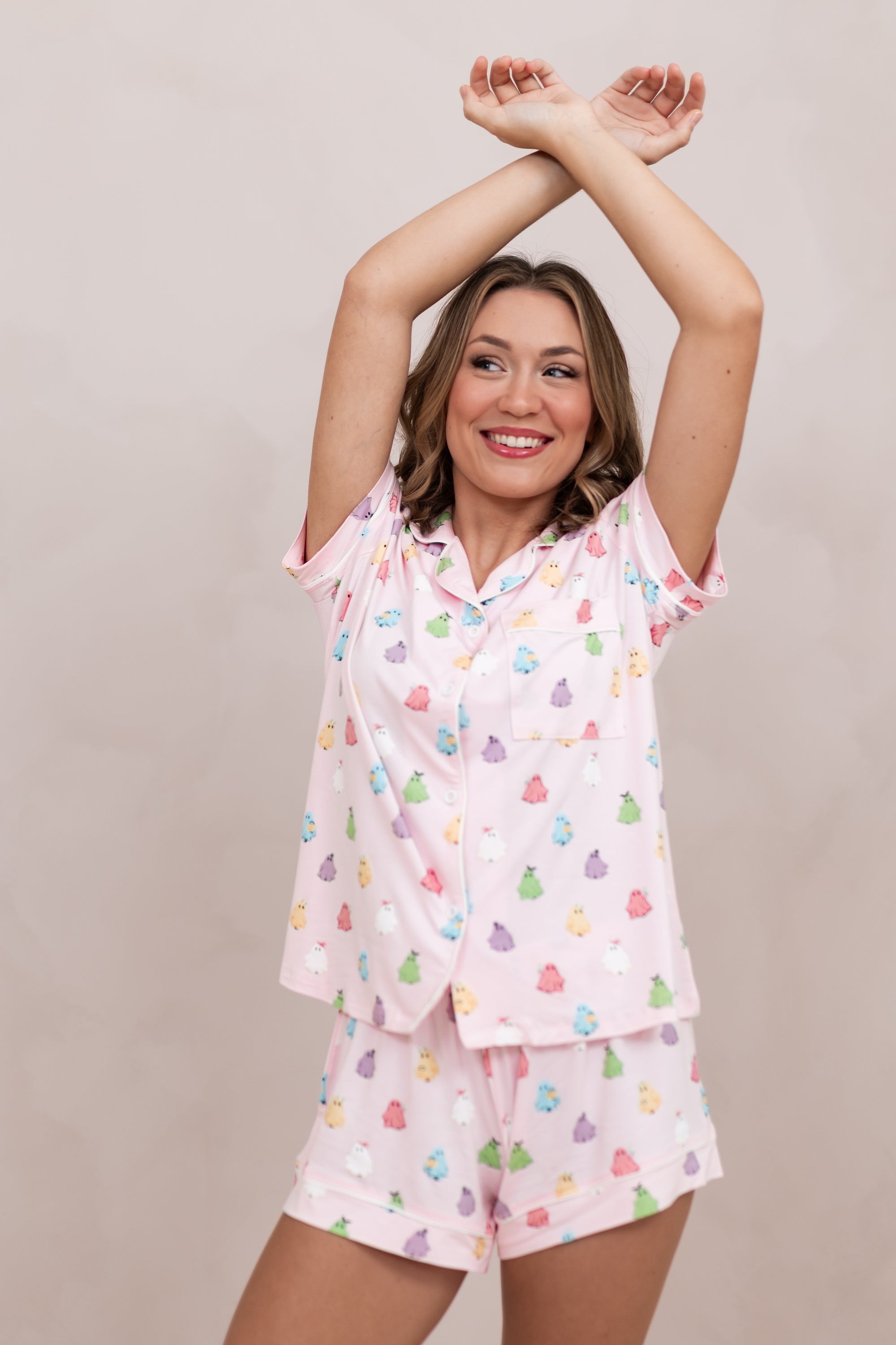 Model with arms over her head while wearing the Bamboo Women's Short Sleeve Pajama Set in Pastel Ghost