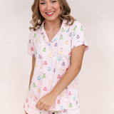 Model with one arm across her front while wearing the Bamboo Women's Short Sleeve Pajama Set in Pastel Ghost