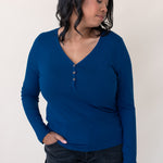 Woman looking to the side and modeling the Women's Long Sleeve Henley Tee in Tahoe