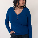 Woman looking to the side and modeling the Women's Long Sleeve Henley Tee in Tahoe