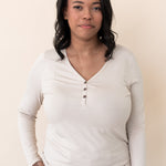 Woman modeling the Kyte Women's Long Sleeve Henley Tee in Bisque