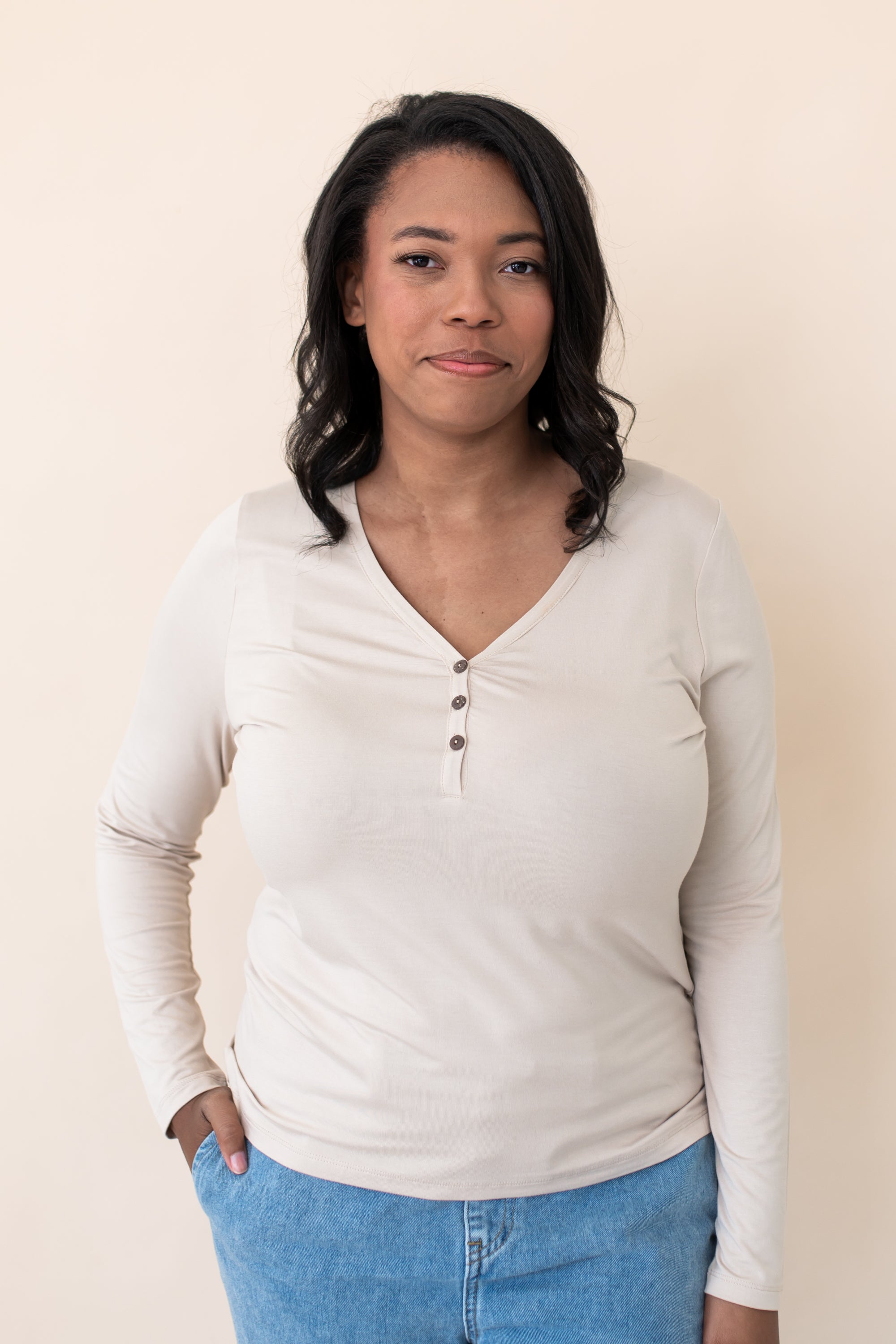 Woman modeling the Kyte Women's Long Sleeve Henley Tee in Bisque