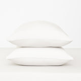 Fitted Sheet with Pillowcases in Cloud. Showing 2 pillows stacked on a sheet