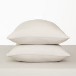 Fitted Sheet with Pillowcases in Oat. Showing 2 pillows stacked on a sheet