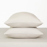 Fitted Sheet with Pillowcases in Oat. Showing 2 pillows stacked on a sheet