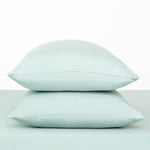 Fitted Sheet with Pillowcases in Sage. Showing 2 pillows stacked on a sheet