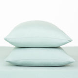 Fitted Sheet with Pillowcases in Sage. Showing 2 pillows stacked on a sheet