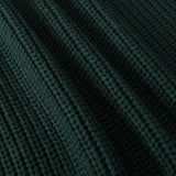 Close-up of a dark forest green ribbed knit fabric texture with a fine waffle pattern.