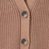Close-up of a ribbed knit cardigan in a warm taupe-beige color, featuring three dark gray buttons down the front center.