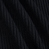 Close-up of a black ribbed knit fabric texture with soft diagonal folds.