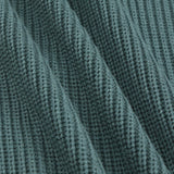 Close-up of a ribbed knit fabric in a muted blue-green color, showing the detailed texture and folds.