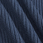 Close-up of a dark navy blue ribbed knit fabric texture with soft diagonal folds.