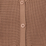Close-up of a brown waffle-knit cardigan sweater showing the button-up front with matching buttons and ribbed trim.