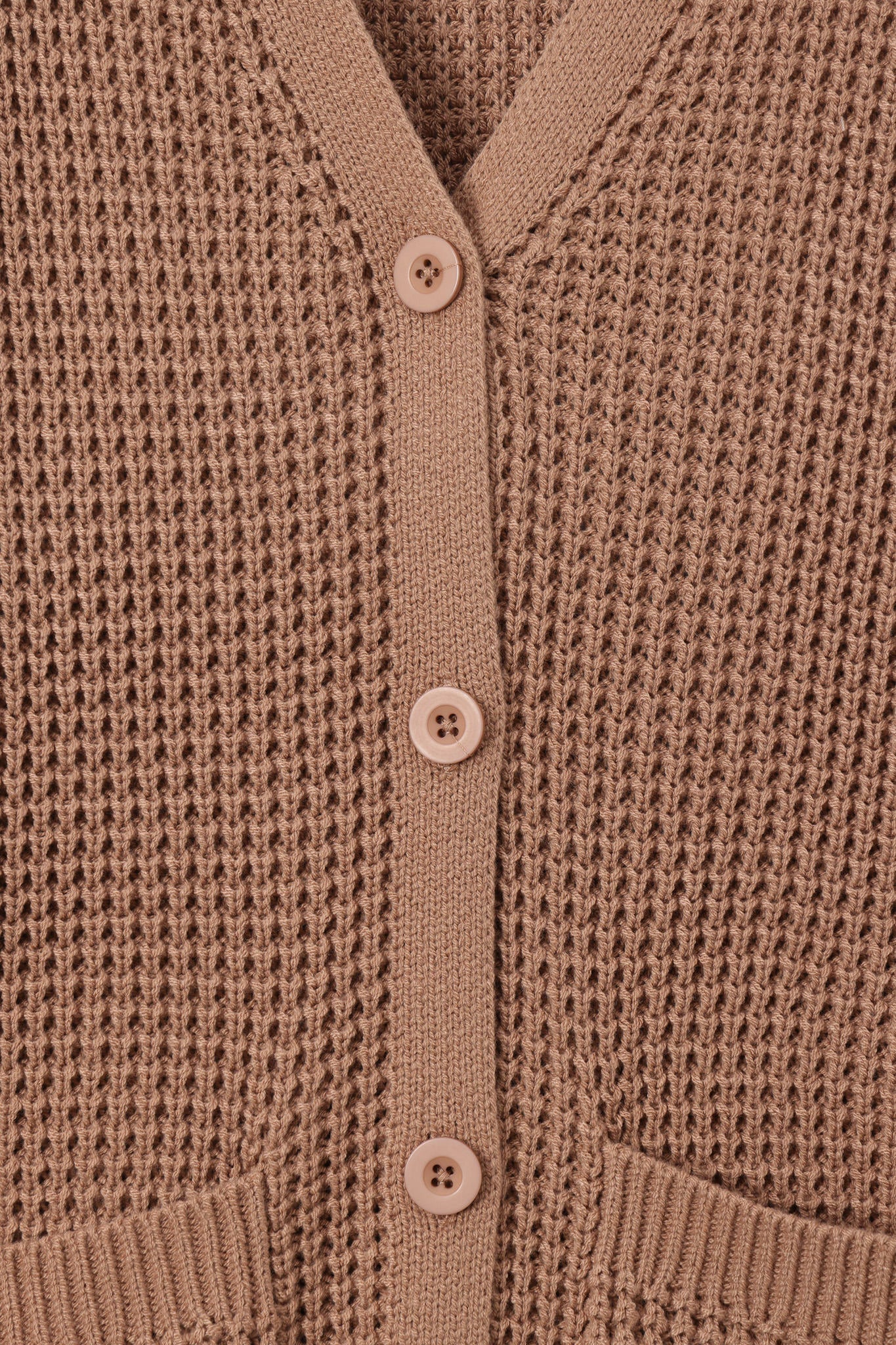 Close-up of a brown waffle-knit cardigan sweater showing the button-up front with matching buttons and ribbed trim.