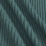 Close-up of a ribbed knit fabric in a muted blue-green color, showing the detailed texture and folds of the material.