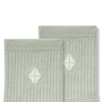 Top part of Adult Crew Socks in Thyme with Kyte Baby logo on a white background