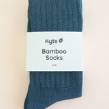 Adult Scrunch Socks in Atlantic shown in its packaging laying on a light neutral background