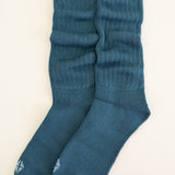 Adult Scrunch Socks in Atlantic shown out of packaging laying side by side on top of a light neutral background