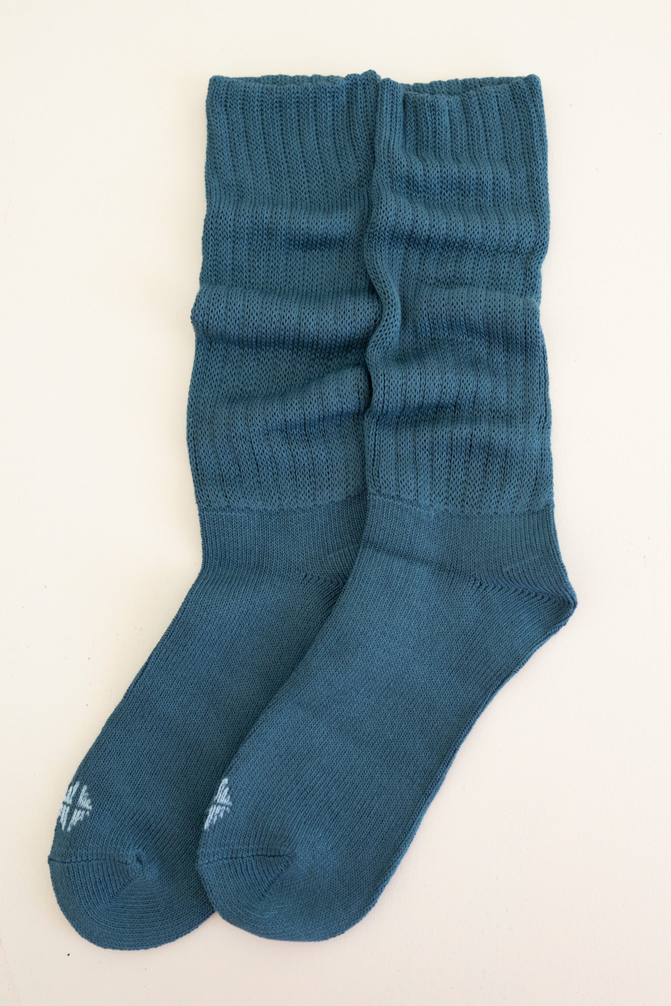 Adult Scrunch Socks in Atlantic shown out of packaging laying side by side on top of a light neutral background