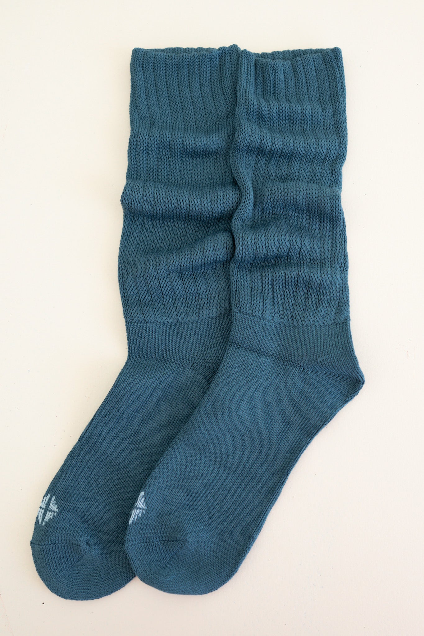 Adult Scrunch Socks in Atlantic shown out of packaging laying side by side on top of a light neutral background