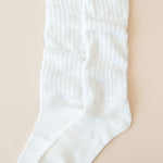 Flat lay of Kyte Scrunch Socks in Cloud with top unfolded