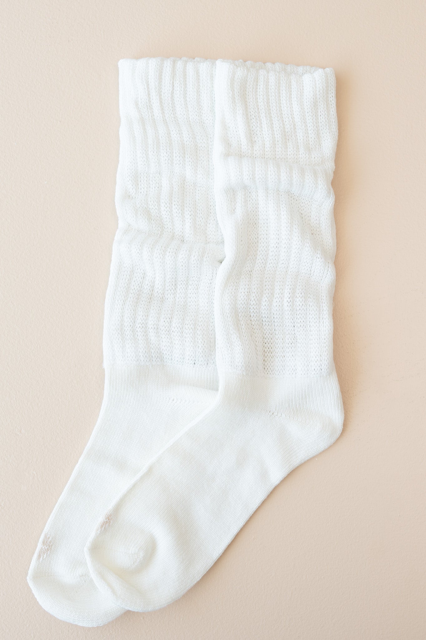 Flat lay of Kyte Scrunch Socks in Cloud with top unfolded