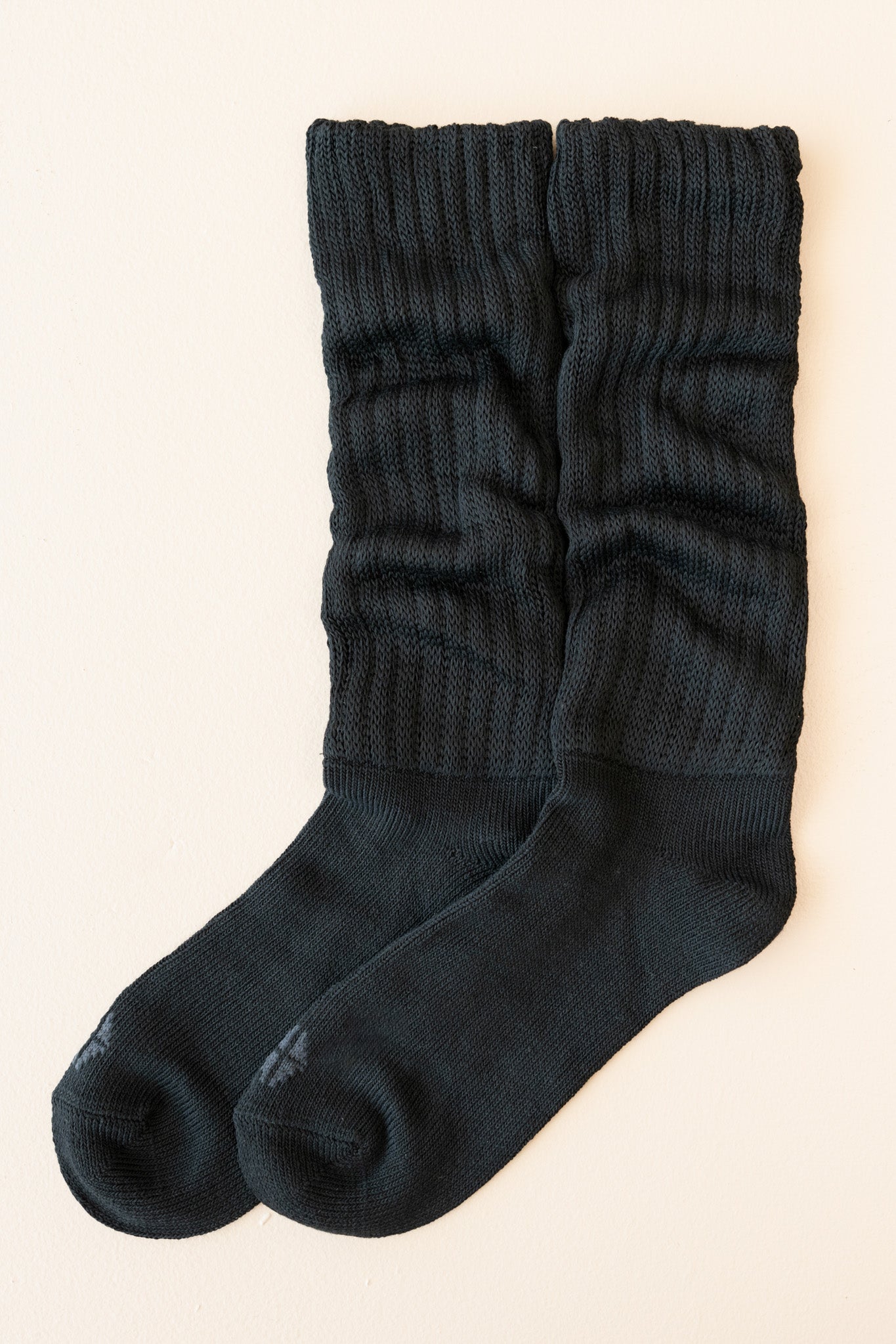 Flat lay of unfolded Scrunch Socks in Midnight