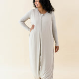Female model wearing the Adult Sleep Bag Walker in Almond