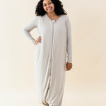 Smiling model wearing the Adult Sleep Bag Walker in Almond