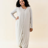 Smiling model wearing the Adult Sleep Bag Walker in Almond