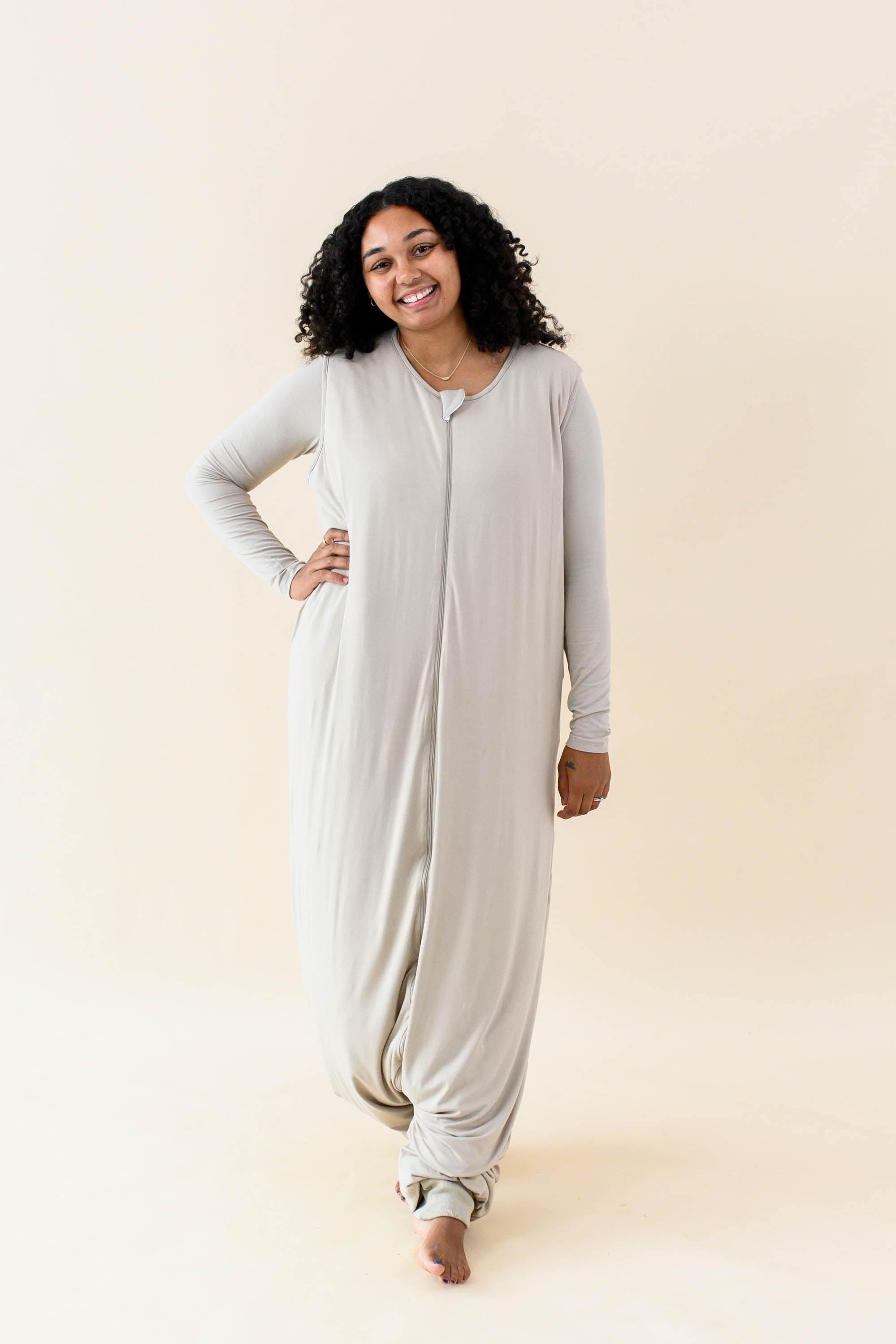 Smiling model wearing the Adult Sleep Bag Walker in Almond