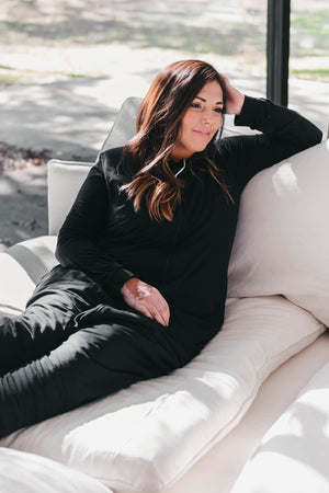 Woman wearing Adult Sleep Bag Walker in Midnight over black pajamas