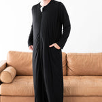 Male model wearing the Adult Sleep Bag Walker in Midnight with one hand in the pocket
