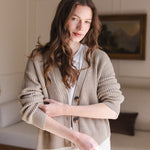 Woman soft smiling pulling up her sleeve wearing a cropped cardigan in almond
::: Model is 5'8" wearing size XS ///
