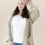 Woman modeling Chunky Knit Women's Oversized Cardigan in Almond and matching Pom Beanie
