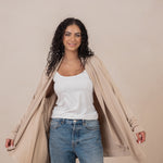 Woman wearing the  Women's French Terry Wrap Top in Almond and opening the sides
