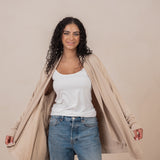 Woman wearing the  Women's French Terry Wrap Top in Almond and opening the sides