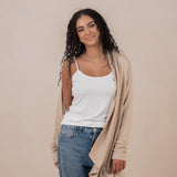 Model with the Women's French Terry Wrap Top in Almond off one shoulder paired with a Cami in Cloud and Jeans