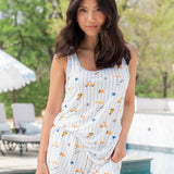 Brunette model standing by a pool with hand on hip while wearing the Women's Tank Set in Amalfi Coast