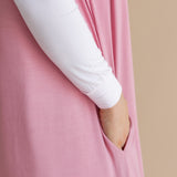 Close up of the model showcasing the pocket on the  Adult Sleep Bag Walker in Apple Blossom