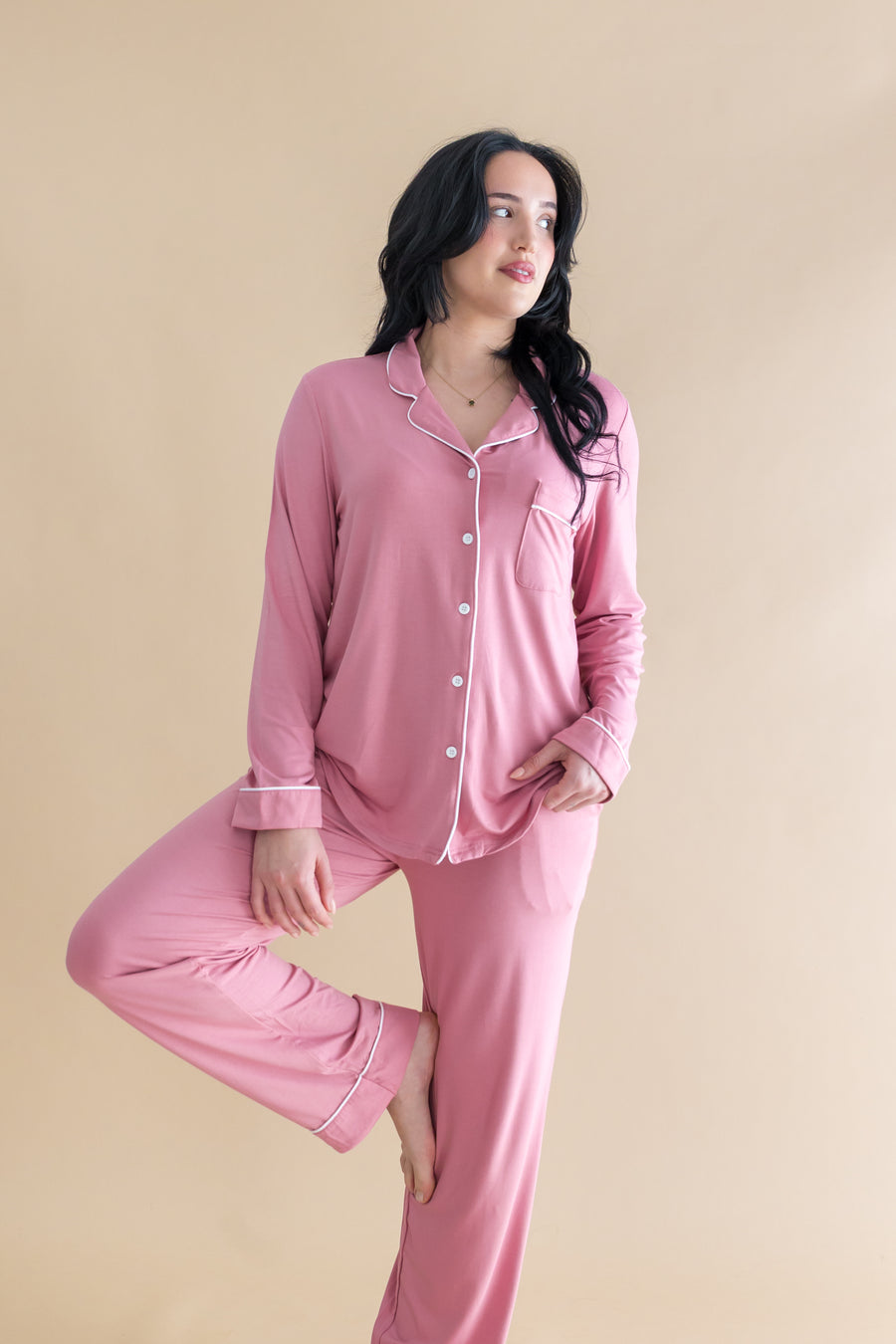 Model  doing a yoga pose while wearing the Long-Sleeved Women's Pajama Set in Apple Blossom with Cloud Trim