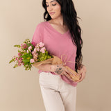 Woman modeling Women’s Relaxed Fit V-Neck in Apple Blossom holding bouquet 