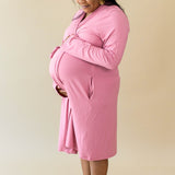 Expectant mother cradling her baby bump wearing the Women’s Lounge Robe in Apple Blossom