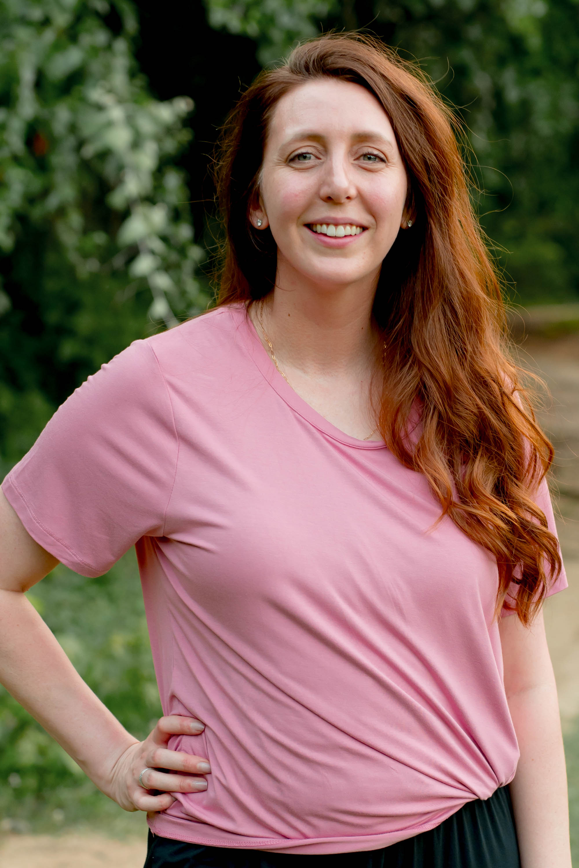 Female model wearing the Women's Crew Neck Tee in Apple Blossom