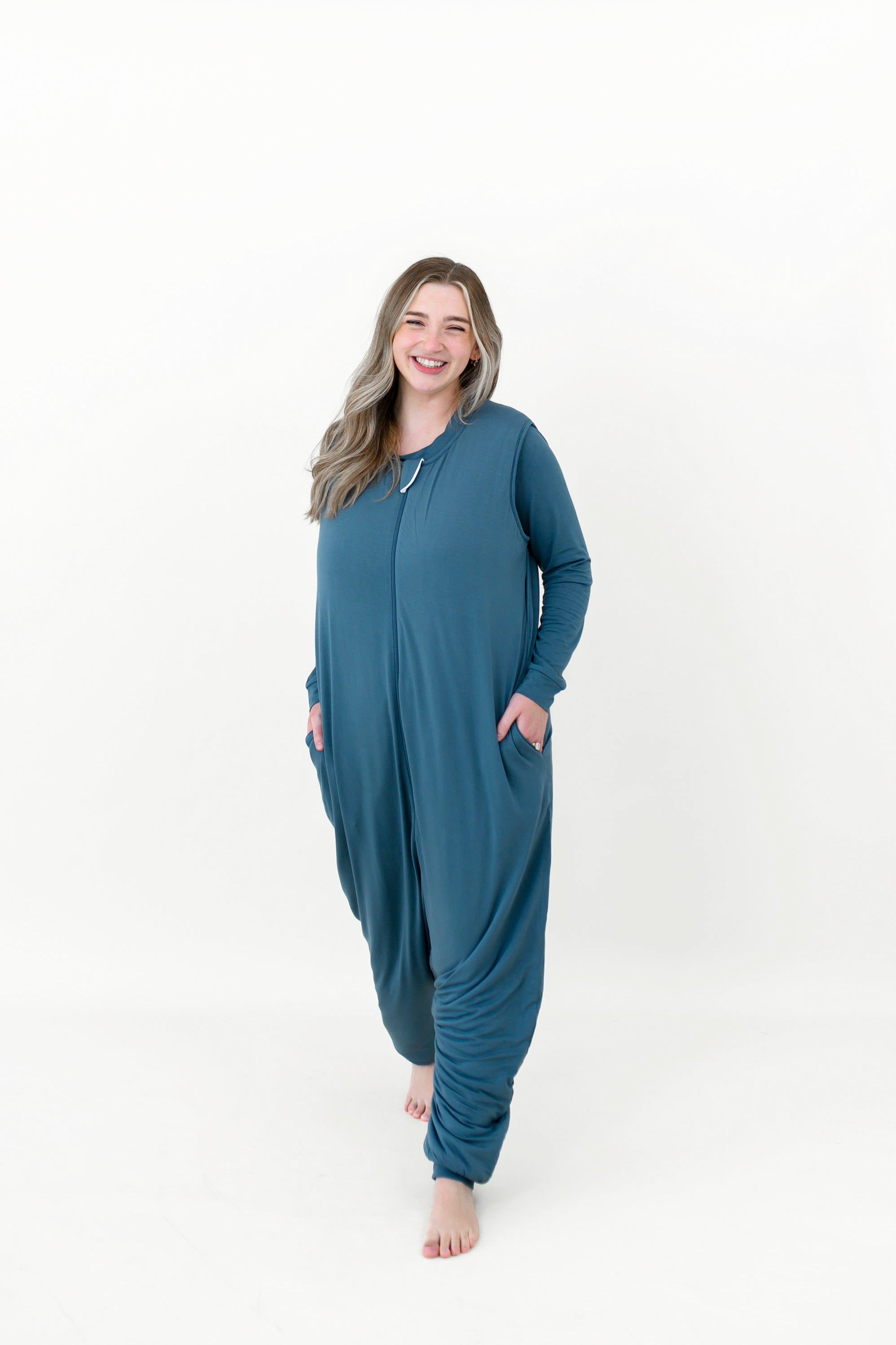 Smiling model wearing the Adult Sleep Bag Walker in Atlantic with her hands in her pocket