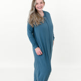 Model standing in a white room while wearing a Kyte Baby Adult Sleep Bag Walker in Adult