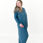 Model looking over her shoulder while wearing the Adult Sleep Bag Walker in Atlantic and smiling