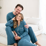 Couple holding each other while wearing Men's Lounge Pants in Atlantic and Women's Long Sleeve Pajama Set in Atlantic